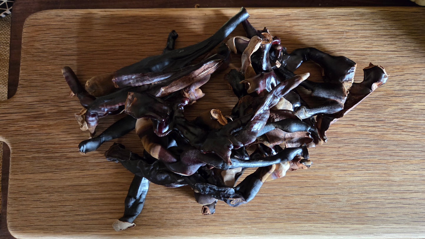 Dried Reishi mushrooms on a wooden surface with a blurred background