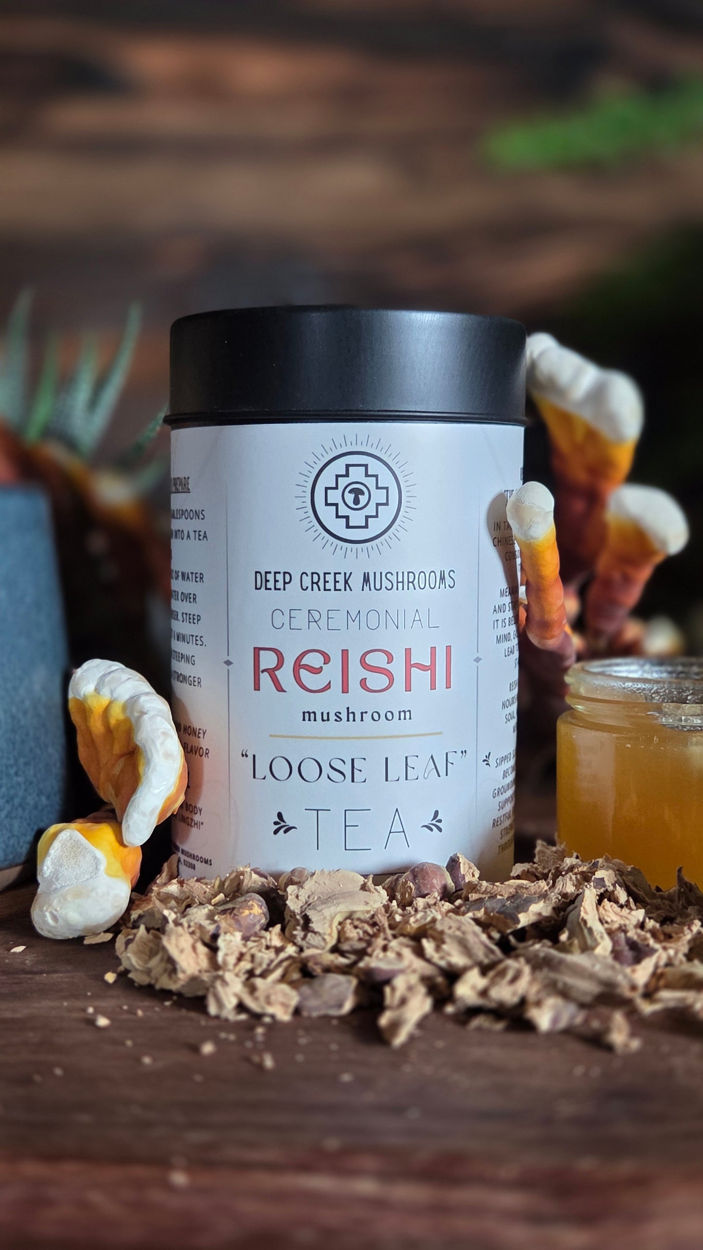 Reishi mushroom tea packaging with tea leaves and mushrooms on a wooden surface