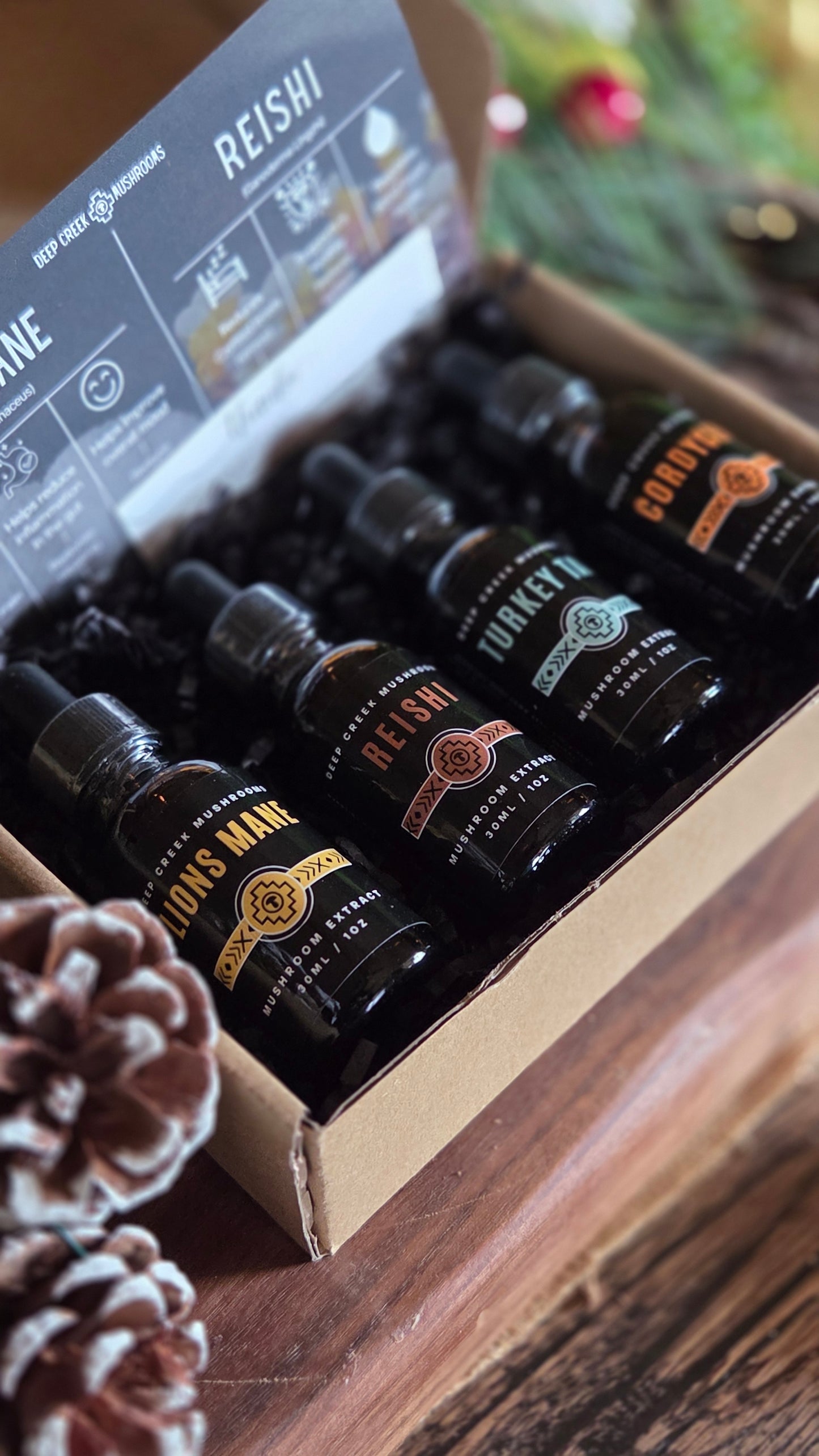 Set of mushroom tincture in a box with decorative elements on a wooden surface