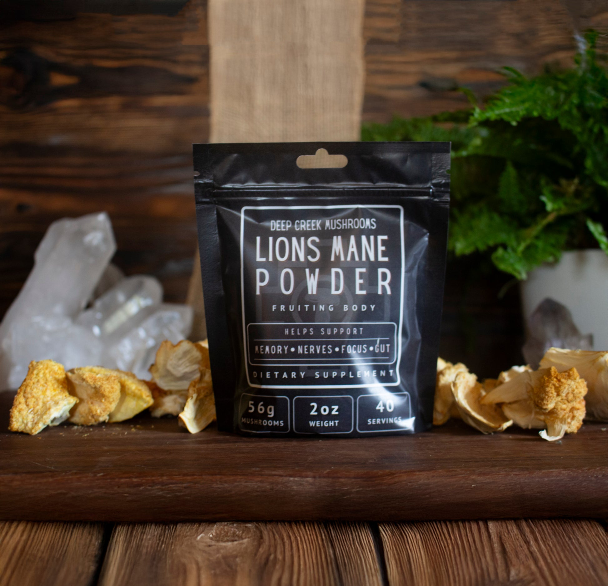 Deep Creek Mushrooms Lions Mane Powder package on a wooden surface with mushrooms and crystals